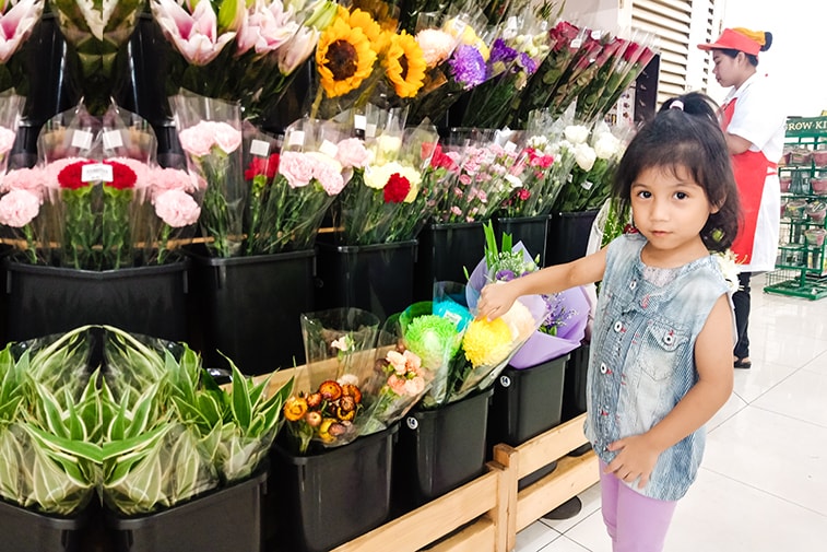 Chantry, 4 years old, standing beside the flower store.